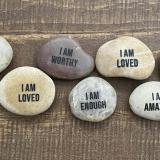 Image of rocks displaying messages of self-affirmation.