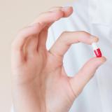 A nurse holds a pill