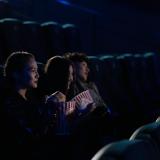 Three people in a movie theater.