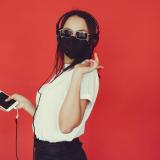 Girl listening to music with mask