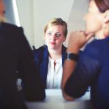 Three women at a meeting.