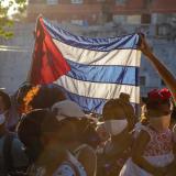 People hold up Cuban flag in Havana 2020