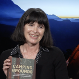 Phoebe Young holding her new book Camping Grounds 