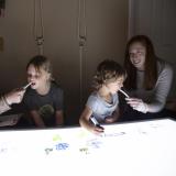 Children play at a light table for part of a sleep study