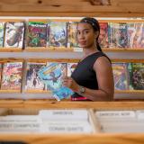 Stephanie Toliver in a comic book store reading an issue of "Ironheart"