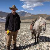 Assistant Professor William Taylor and a horse