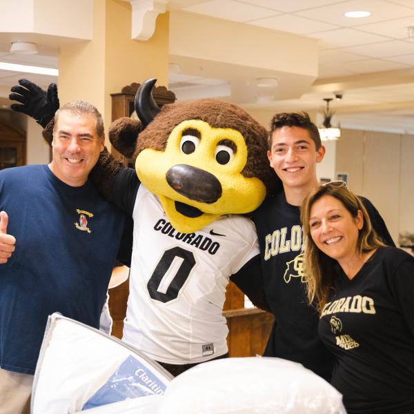 Family poses with Chip the buffalo mascot during move-in