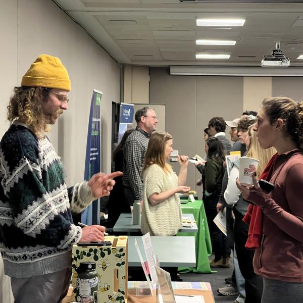 student speaks with an employer at the first Career in the Environment Fair