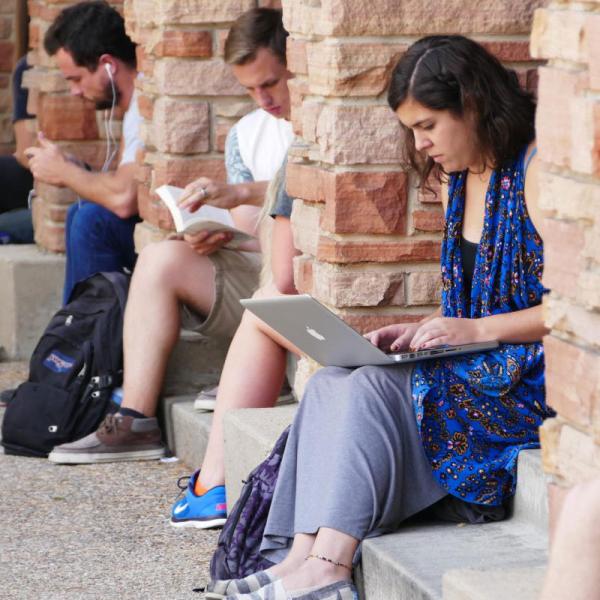 students on laptops in UMC breezeway