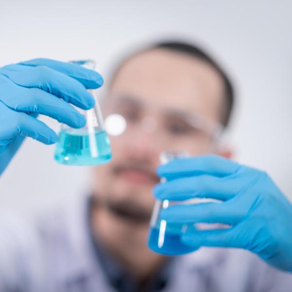 A scientist with beakers