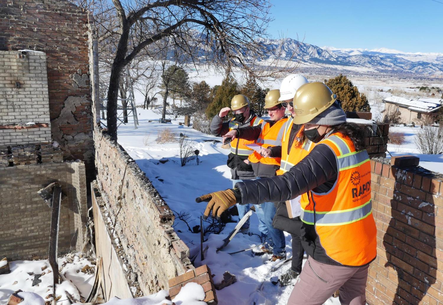 University of Colorado Boulder engineering students survey a home destroyed by the Marshall Fire