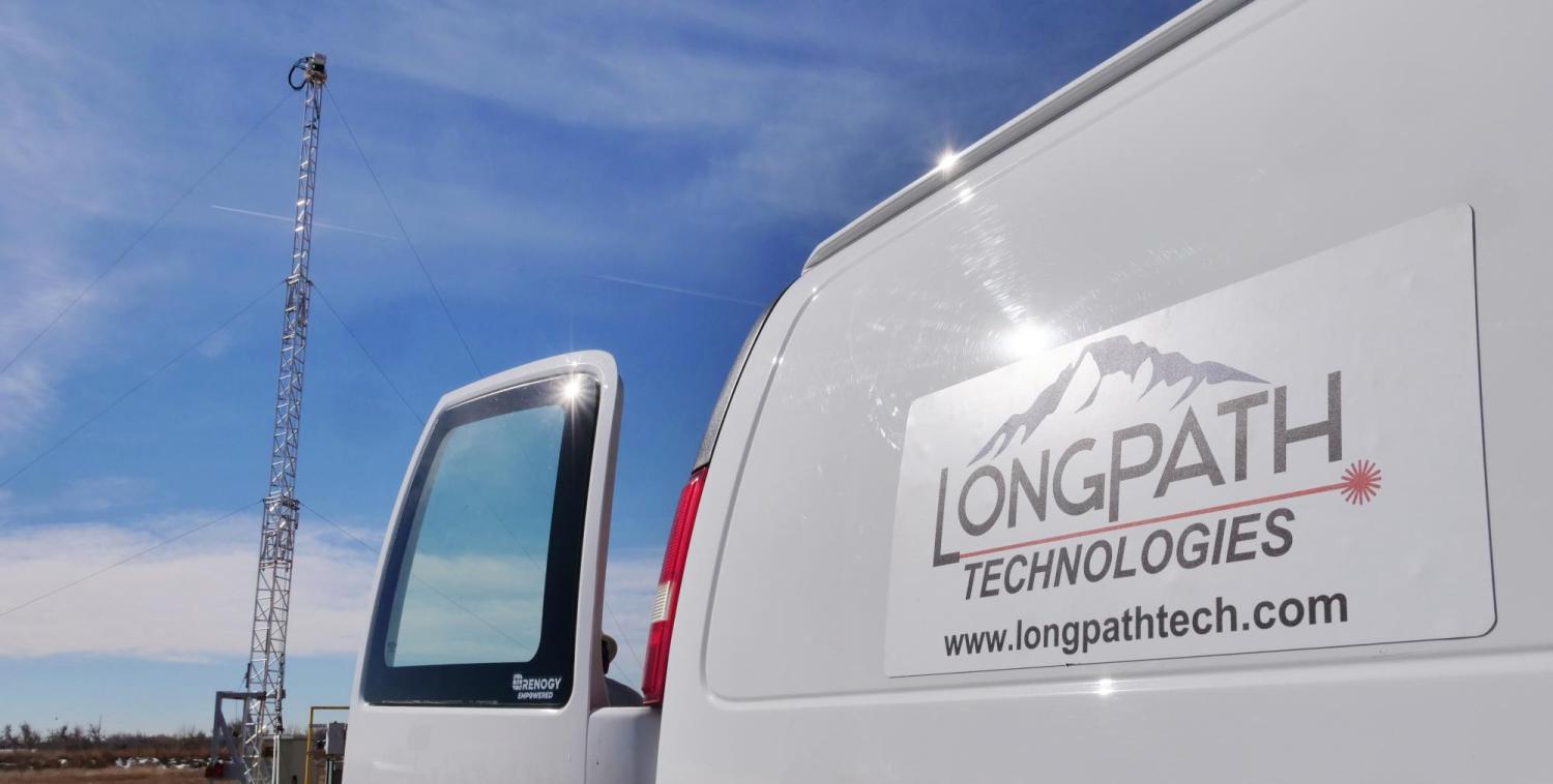 A truck labeled "LongPath Technologies" parks near a tower