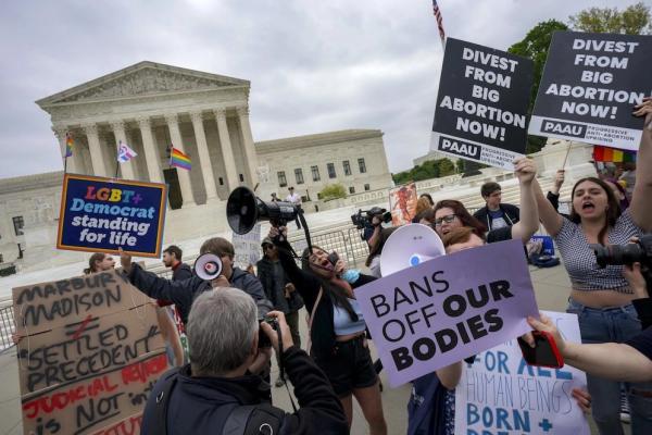 Anti-abortion protesters use bullhorns to counter abortion rights advocates outside the Supreme Court on May 3, 2022