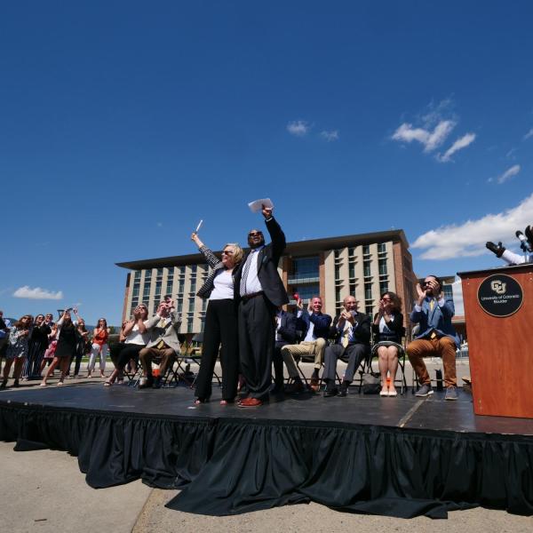 Ann Smead, left, and Brian Argrow, chair of the aerospace engineering department, cut a ribbon held by drones at a ceremony at the new Aerospace Engineering Sciences Building at CU Boulder. (Photo by Glenn Asakawa/CU Boulder)