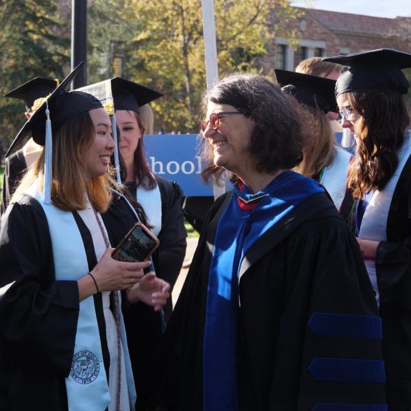 Students and faculty gather on the quad before processing to Folsom Stadium