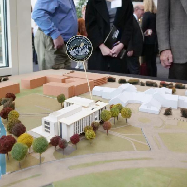 Onlookers check out a model of the new aerospace engineering sciences building