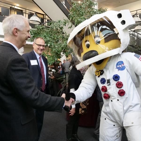 Professor David Klaus shakes hands with Chip at the groundbreaking ceremony