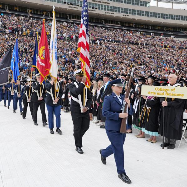 The Naval ROTC Color Guard enters Folsom Field