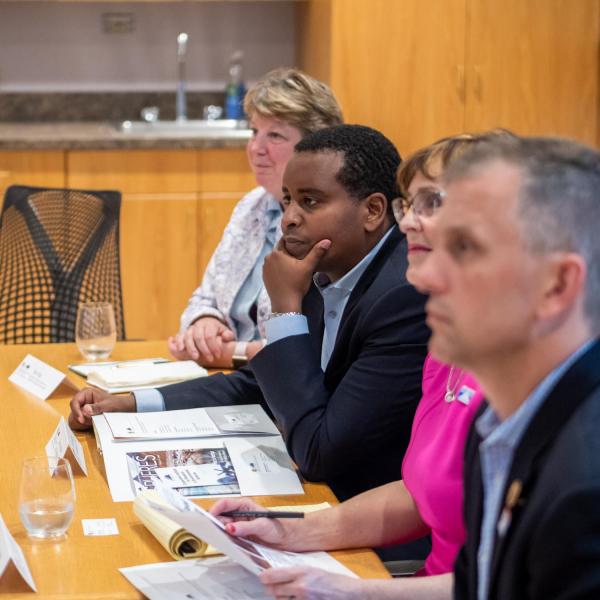 Congressman Joe Neguse (second from left) listens during a discussion about the work being done at CIRES. (Photo by Patrick Campbell/University of Colorado)