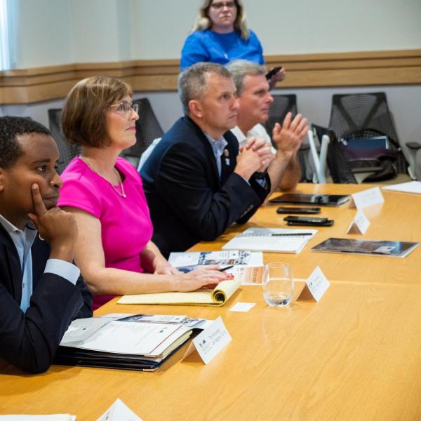 Congressman Joe Neguse (second from left) listens during a discussion about the work being done at CIRES. (Photo by Patrick Campbell/University of Colorado)