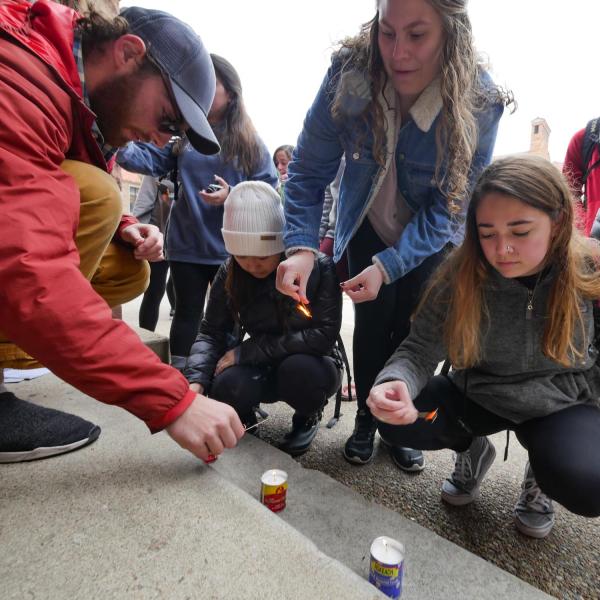 Students, faculty and staff line up to light candles in honor of those killed and to show solidarity of support against anti-semitism. Photo by Glenn Asakawa.