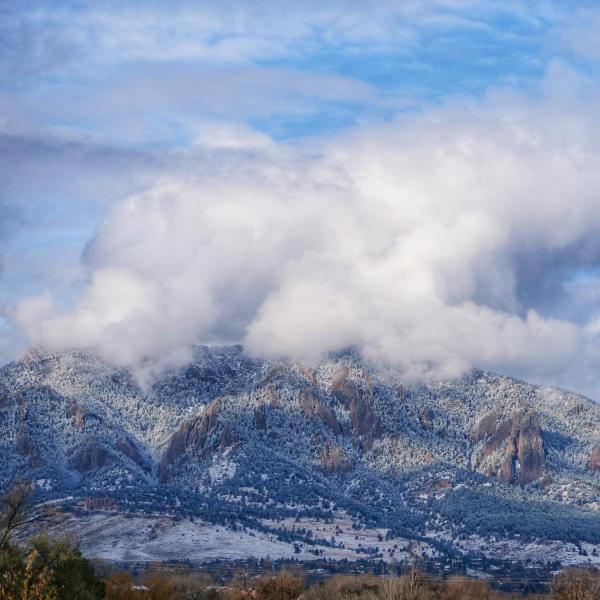 Flatirons the day of Halloween, dusted in snow with eery clouds above. Photo by Glenn Asakawa.