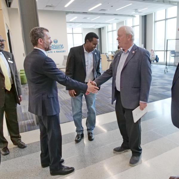 CU President Todd Saliman shakes hands with Congressman Jerry McNerney, California, as Congressman Donald Norcross, New Jersey, looks on. In the background are CU Boulder’s Brian Argrow and U.S. Rep. Joe Neguse.