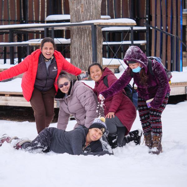 Kittredge residence hall facilities management workers play in the snow outside their building on Jan. 27. (Photo by Glenn Asakawa/University of Colorado)