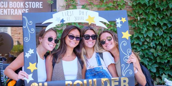 Students pose for a photo in a CU Boulder frame on the first day of classes in 2022