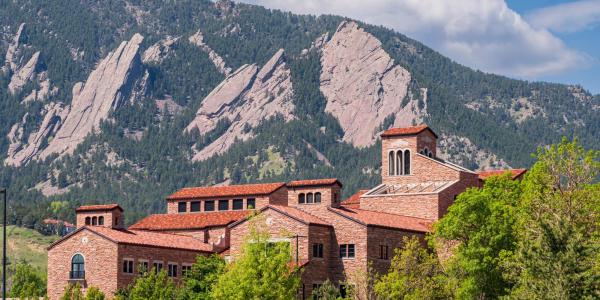 top of a campus building with Flatirons in the background