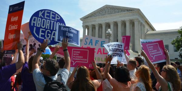 people gathering with signs during a pro-choice rally