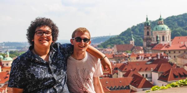Two students in front of Prague, Czech Republic, cityscape