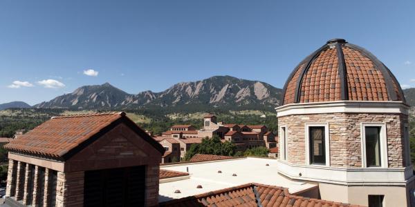 Tops of campus buildings with Flatirons in the background