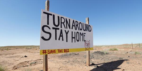 Navajo Nation sign that reads 'Turn around. Stay home'
