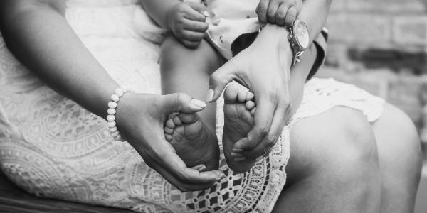 A mother holding a baby's feet