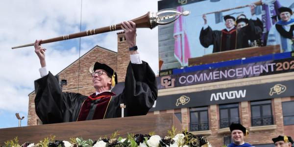 Bud Coleman holds the mace during the 2022 commencement ceremony