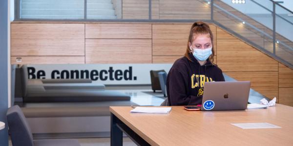 student in mask on campus