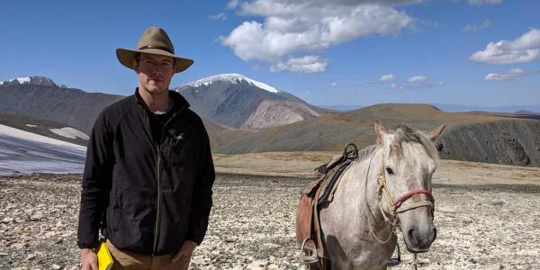 Assistant Professor William Taylor and a horse