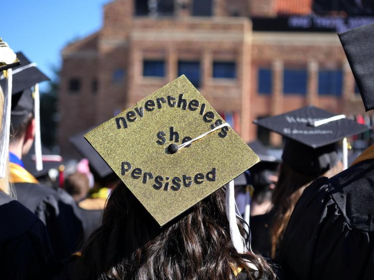 Graduation cap decorated to say "Nevertheless she persisted"