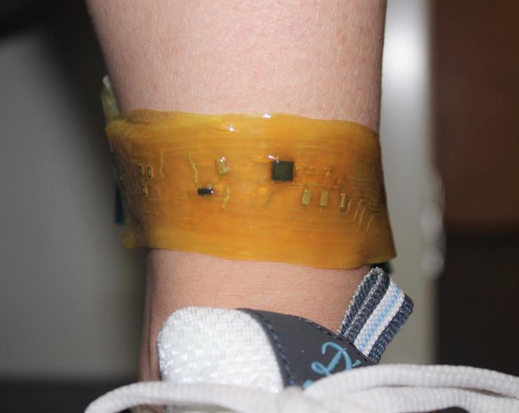 A person wears an "electronic skin" device on the ankle.