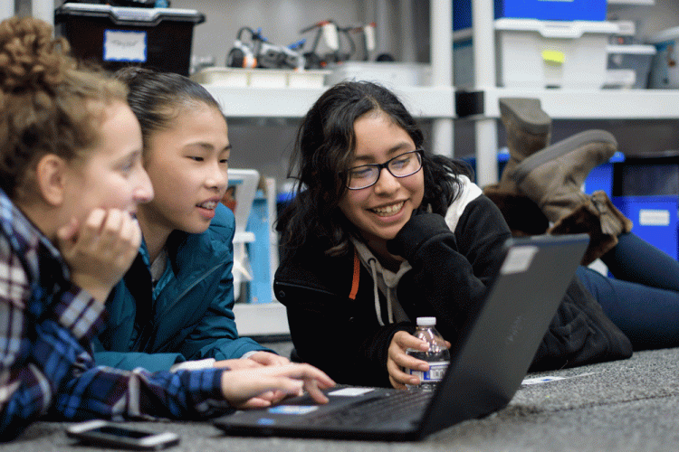 Young girls work together on computer science project