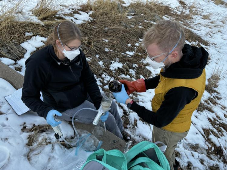 Environmental engineering faculty Julie Korak and Cresten Mansfeldt collect water samples