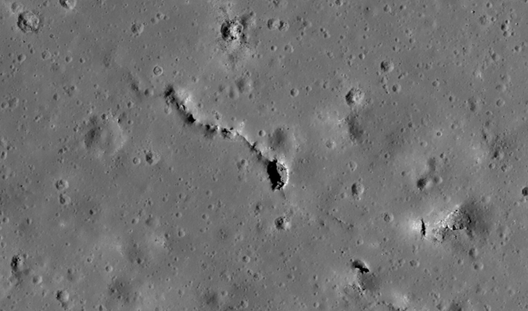 A pit in a fracture on the lunar surface.