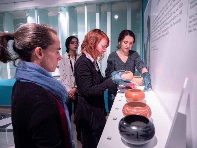 Museum staff get ready a display of bowls