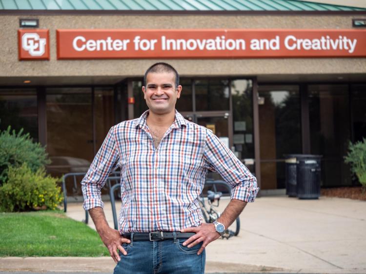 Sidney D'Mello stands in front of the Center for Innovation and Creativity building on the CU Boulder campus.
