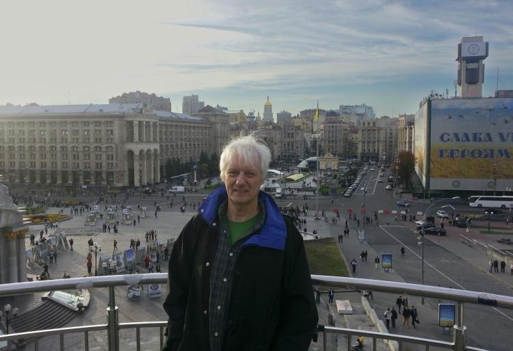 John O'Loughlin stands on balcony above city square in Kyiv