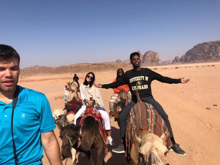 CU students riding camels in Jordan