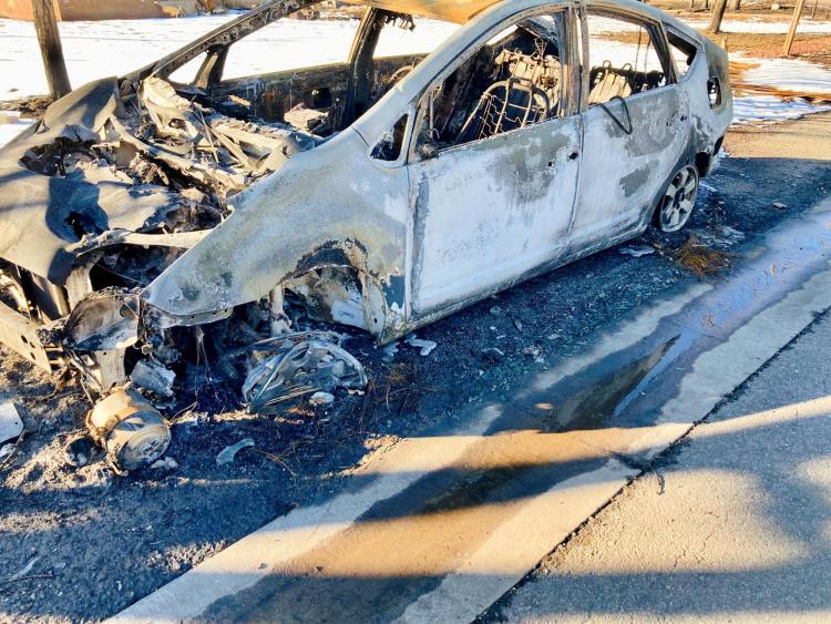 A burnt car after the Marshall Fire.