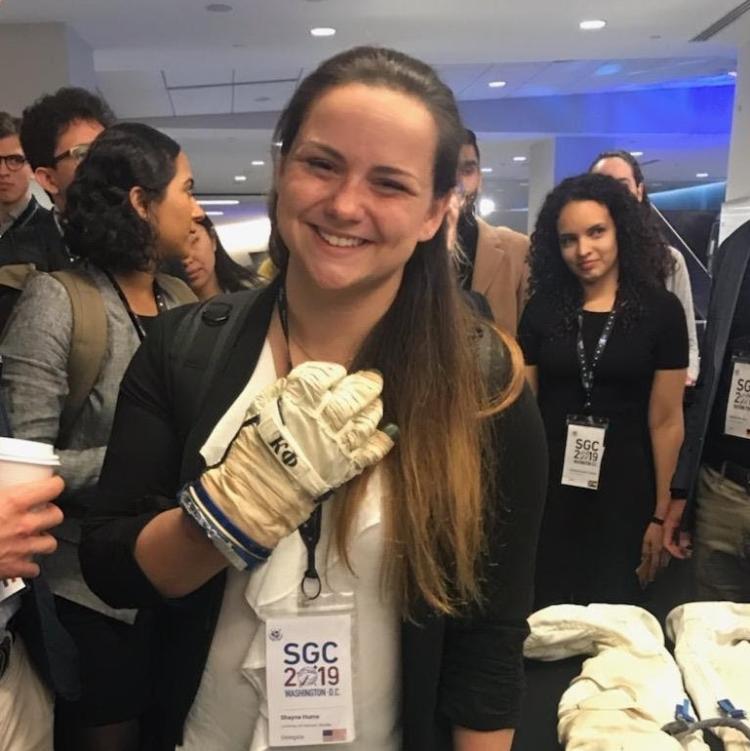 Shayna Hume wearing a spacesuit glove