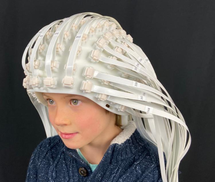 Child wears helmet made up of dozens of sensors